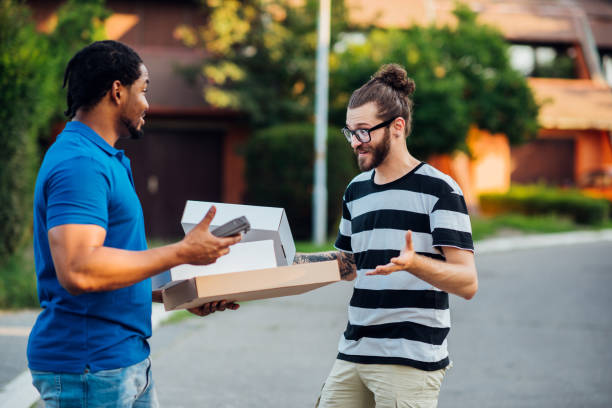 istock Delivery guy delivering products to his customer 1215895438