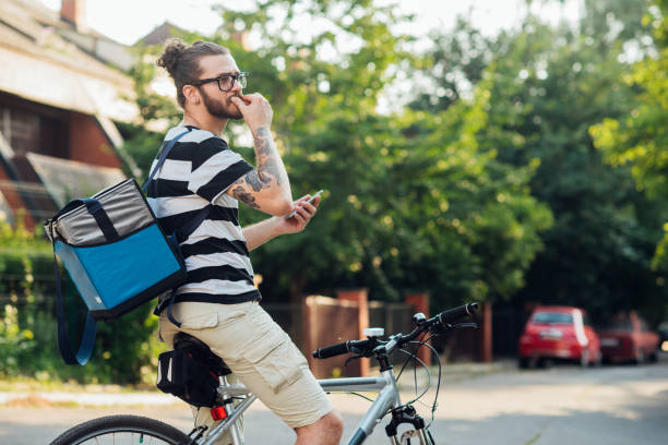 istock Delivery guy searching for the address he's delivering to 1215895487