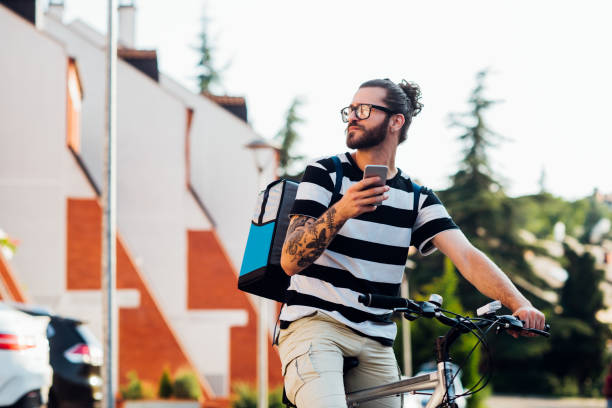 istock Young delivery guy delivering products to the customers in quarantine 1215895489