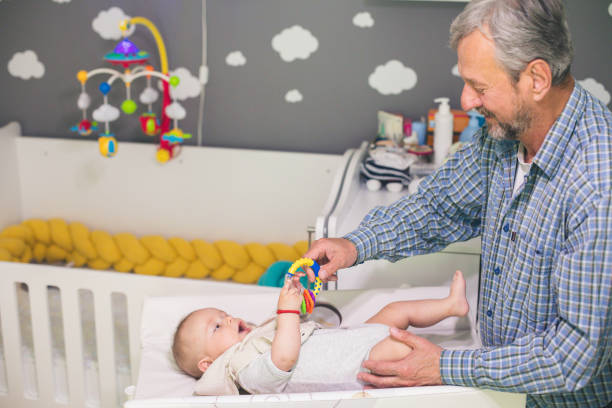 istock Senior man playing with his grandson at home 1215897605