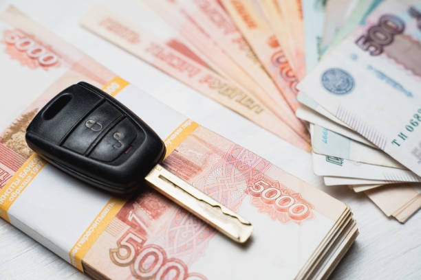 istock car key lies on a bundle with rubles banknotes 1215899217
