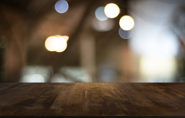 istock Wood Table Top in Blur Background room interior with empty copy space. 1215899387