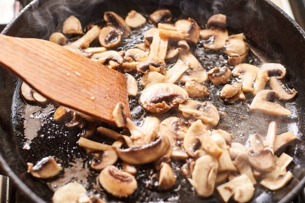 istock Fried mushrooms in a pan. Cooking mushrooms with steam emanating from them. 1215900959
