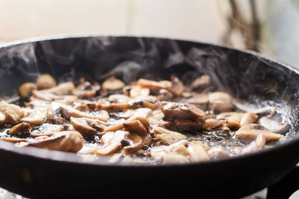 istock Fried mushrooms in a pan. Cooking mushrooms with steam emanating from them. 1215900961