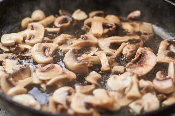 istock Fried mushrooms in a pan. Cooking mushrooms with steam emanating from them. 1215900964