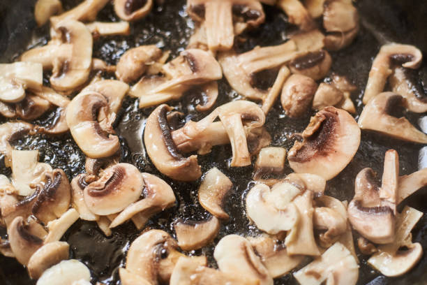 istock Fried mushrooms in a pan. Cooking mushrooms with steam emanating from them. 1215900974