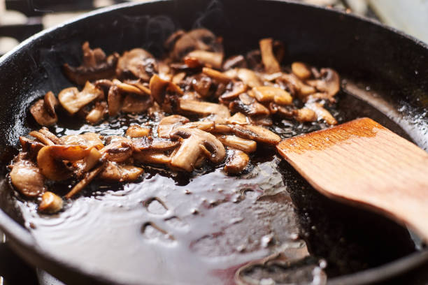 istock Fried mushrooms in a pan. Cooking mushrooms with steam emanating from them. 1215900980