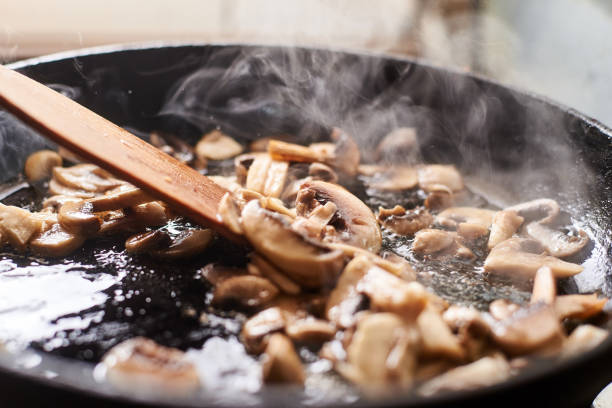 istock Fried mushrooms in a pan. Cooking mushrooms with steam emanating from them. 1215900985