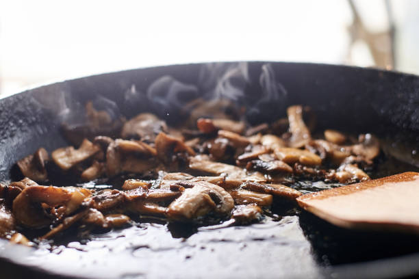istock Fried mushrooms in a pan. Cooking mushrooms with steam emanating from them. 1215900996