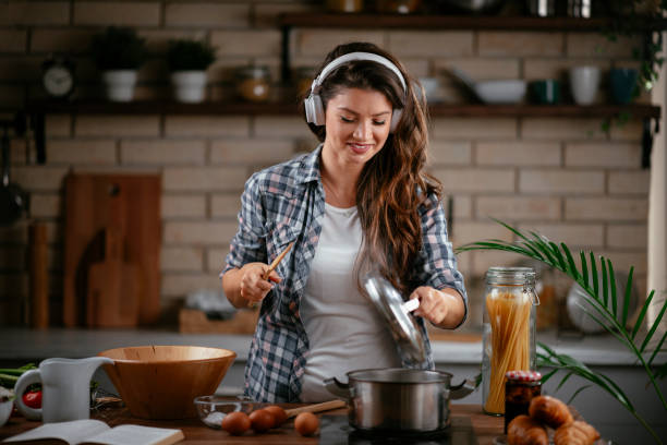 istock Young woman preparing food in kitchen 1215901342