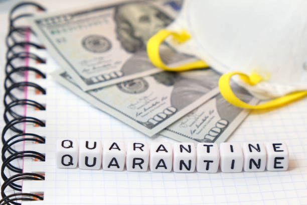 istock Word Quarantine, Protective mask and USA Dollars bank notes on a white paper notebook background. 1215902050