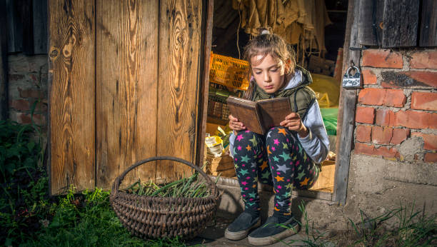 istock A girl reads a book in the barn. 1215902140