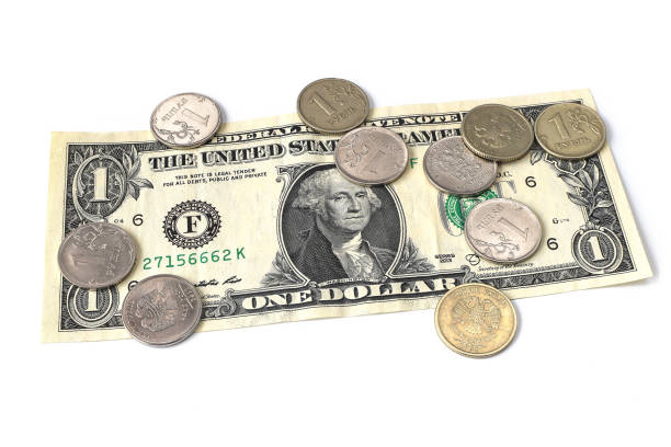 istock coin ruble on the background bills dollar. 1215902858