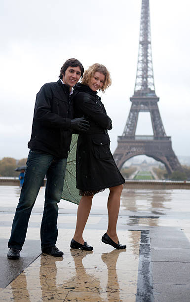 istock Happy couple near the Eiffel tower at rain 121590305