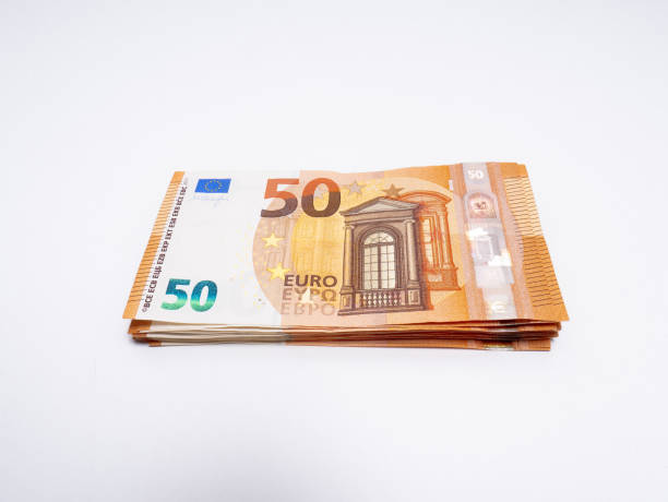 istock Bundle of fifty euro bills on white background 1215904155