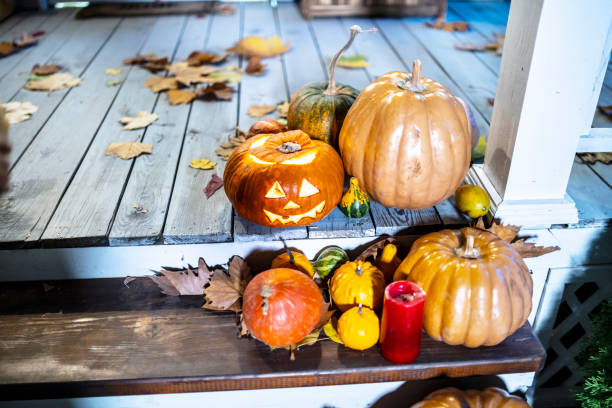 istock Pumpkin on the front door to a home 1215905895