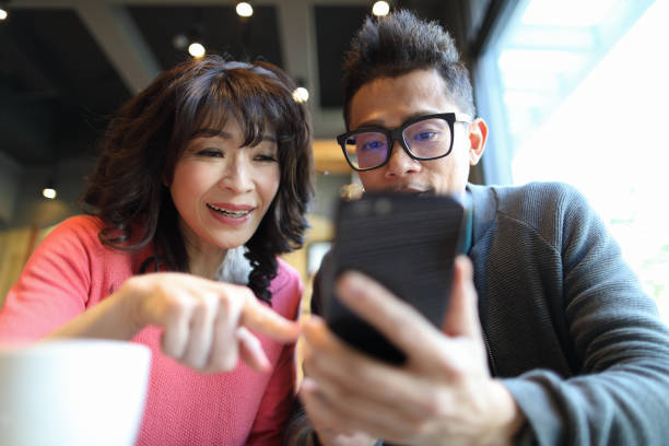 istock Sharing funny memories on smart phone 1215907464