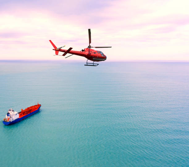 istock Helicopter flying over a ship in the ocean 1215907683