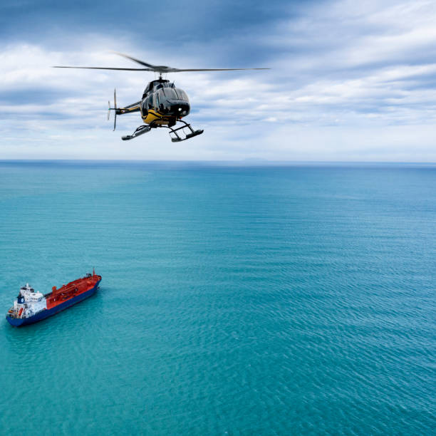 istock Helicopter flying over a ship in the ocean 1215907687