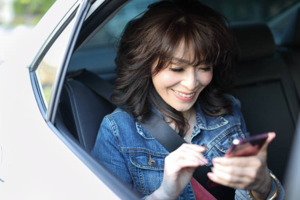 istock Woman using a smart phone in a car 1215907703