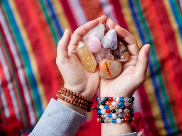 woman holding  healing crystals and colorful stones,shaman - fire match women flame imagens e fotografias de stock