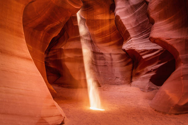 Magical Antelope Canyon Sunbeam Arizona USA Beautiful majestic Sunbeam Spotlight inside the colorful Antelope Canyon Rock Archway, Rock Textures and Shades in the early morning light. Page, Arizona, USA, North America. upper antelope canyon stock pictures, royalty-free photos & images