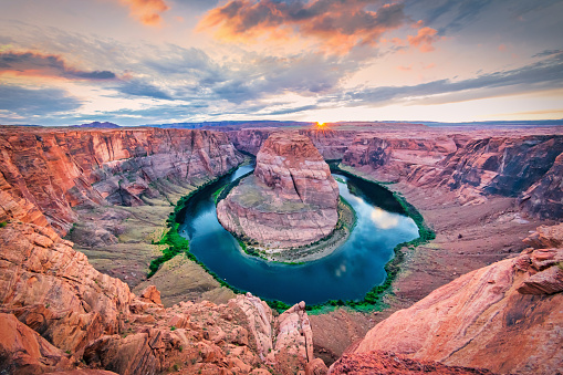 Sunset Twilight over famous Horseshoe Bend. Scenic view over the Arizona Horseshoe Bend - Horseshoe Canyon at dusk with Colorado River in Glen Canyon. Ultra Wide Angle Panorama shot. Page, Arizona, USA, North America.