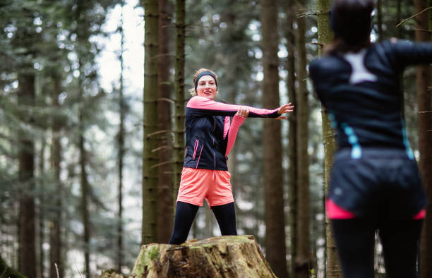 istock Female athletes exercising in the woods 1215910919