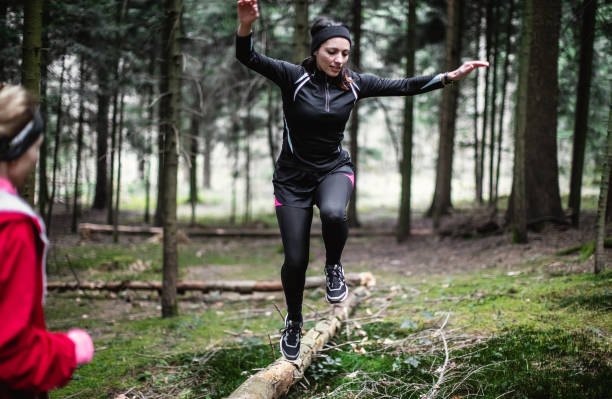 istock Female athletes exercising in the woods 1215912246