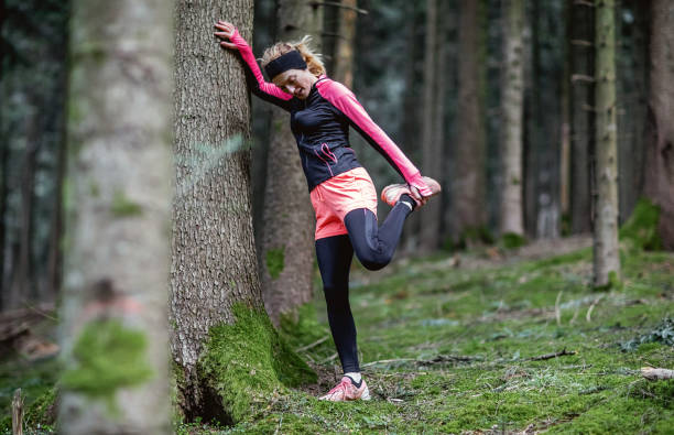istock Female athlete exercising in the woods 1215912285