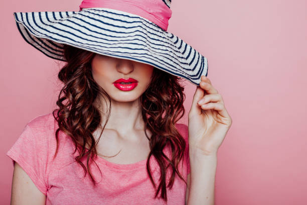 istock beautiful woman in pink in a hat with big fields 1215912520