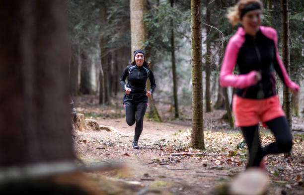 istock Female athletes running in the woods 1215912564
