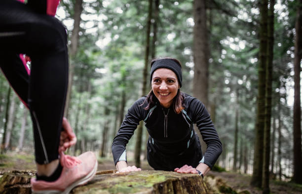 istock Female athletes exercising in the woods 1215913146