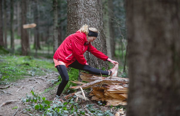 istock Female athlete exercising in the woods 1215913375