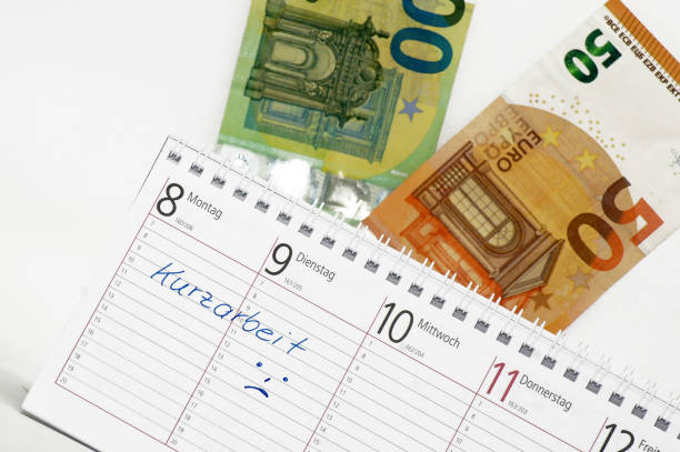 istock Short-time work in the finance calendar lettering 1215915723