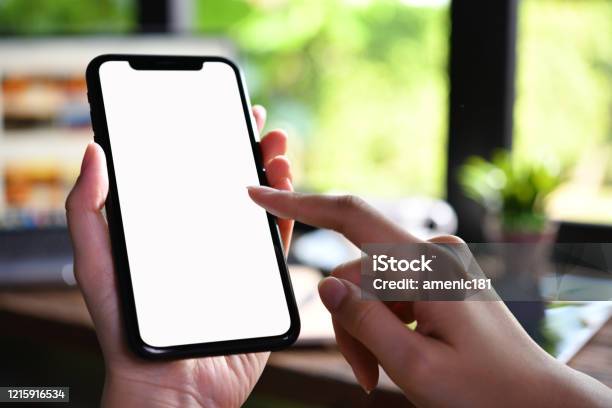 Closeup Image Of Female Hands Using Smartphone With Blank White Screen In The Coffee Shop Stock Photo - Download Image Now