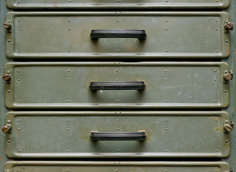 Backgrounds and textures: old green metal closet with pullout drawers, close-up shot