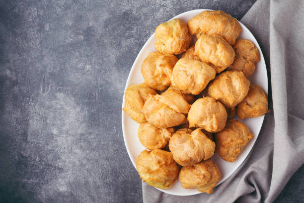 istock Top view on profitroles on white plate. 1215917660