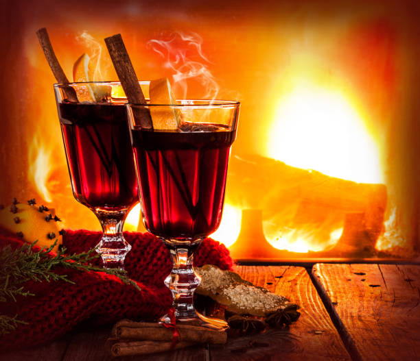 istock Hot mulled wine on fireplace background - winter warming drink 1215917802