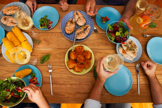 istock Hands of a group of people cheering with white wine 1215918204