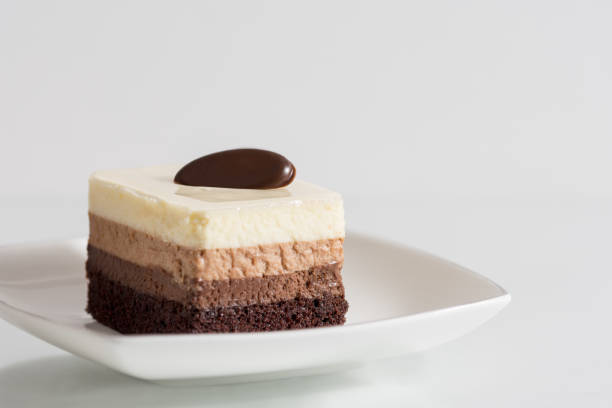 istock Tasty cake with chocolate mousse on white background 1215919460