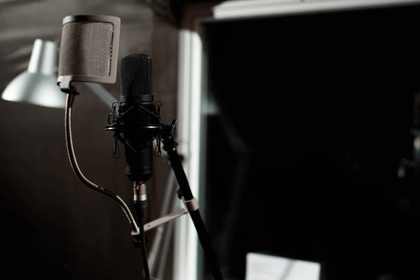 istock Black vocal microphone is stand in sound recording studio room u 1215919635