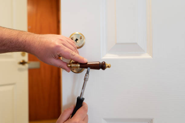 istock Man repairing white door lock with screwdriver. Close-up 1215921403