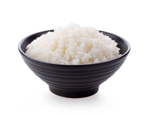 istock Rice in a black bowl on a white background 1215923364