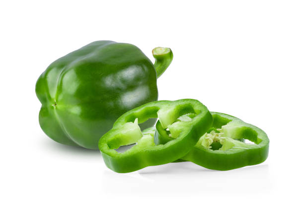 istock Green pepper full depth of field on white background 1215923420