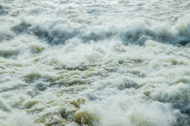 istock Splashing water waves on the spring fast river 1215924052