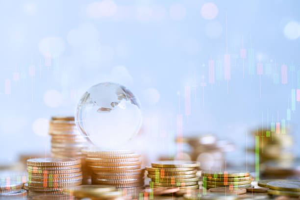 istock Coins stack and financial stock market graph. 1215925226