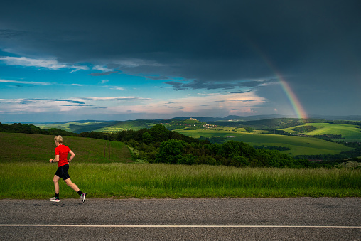 Runner and rainbow, training in summer nature