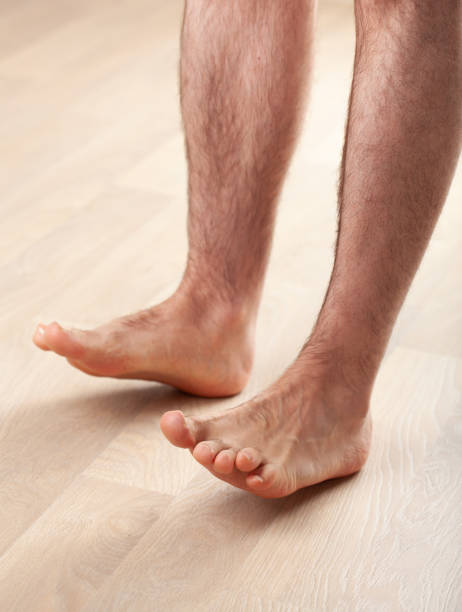 istock man doing flatfoot correction gymnastic exercise toe lifts at home 1215926558