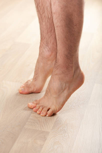 istock man doing flatfoot correction gymnastic exercise standing on toes at home 1215926728